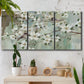 Three-panel canvas wall art featuring delicate spring blossoms with birds, displayed in a boho-chic entryway above a console table.