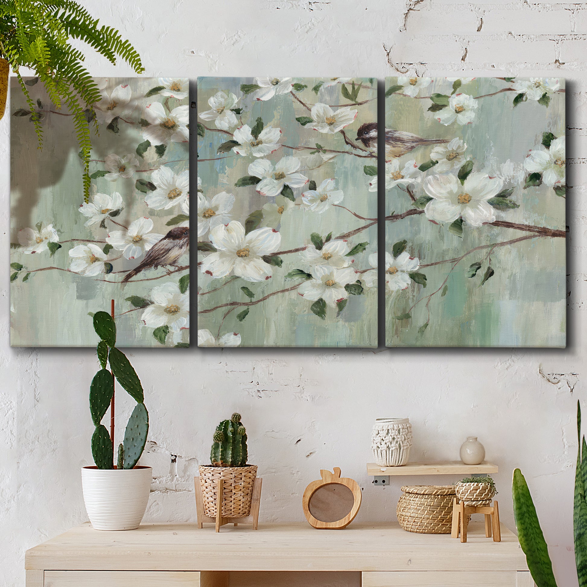 Three-panel canvas wall art featuring delicate spring blossoms with birds, displayed in a boho-chic entryway above a console table.