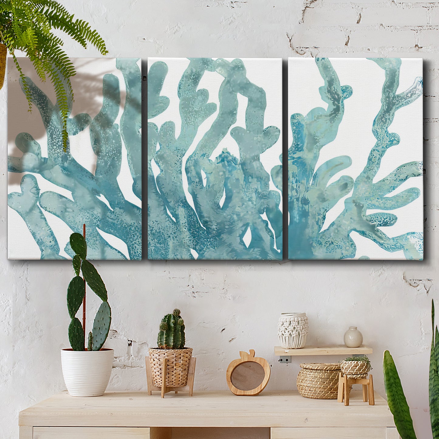 Three-panel canvas wall art featuring blue coral inspired watercolor, displayed in a boho-chic entryway above a console table.
