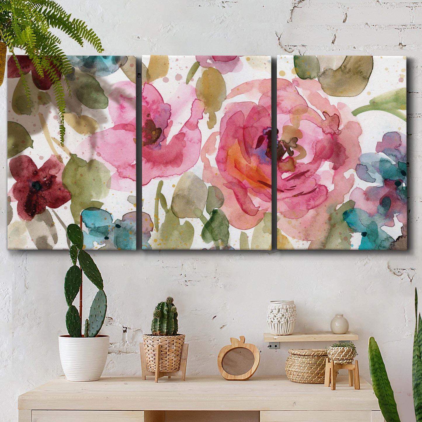 Three-panel canvas wall art featuring colorful floral watercolor composition, displayed in a boho-chic entryway above a console table.