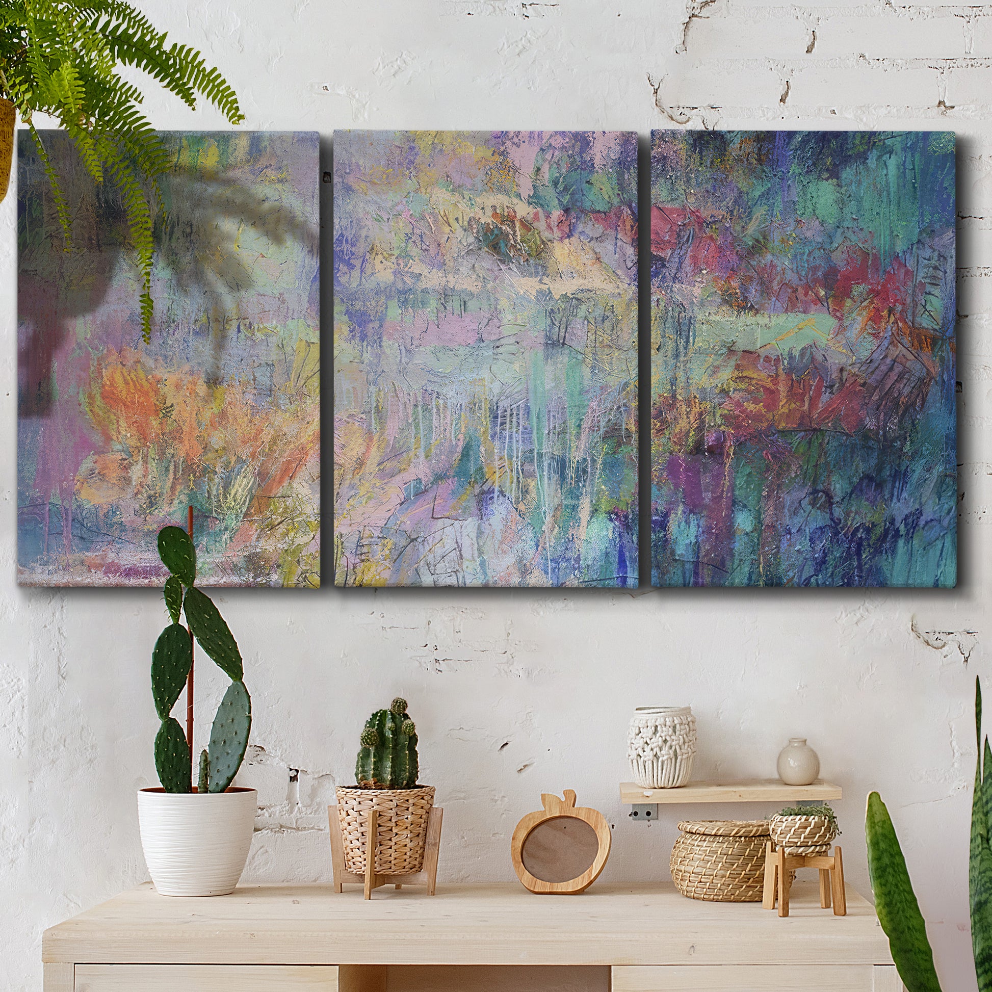 Three-panel canvas wall art featuring abstract evening landscape with depth, displayed in a boho-chic entryway above a console table.
