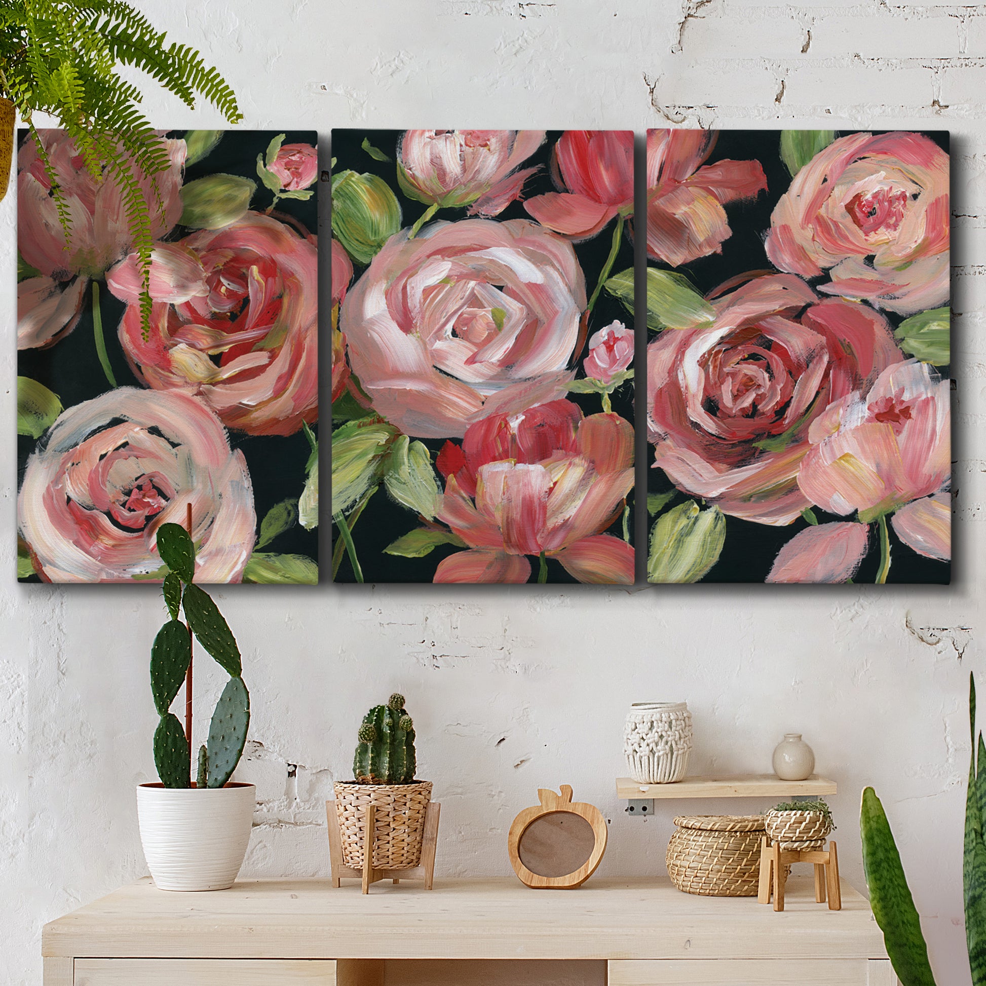 Three-panel canvas wall art featuring bold red floral abstraction, displayed in a boho-chic entryway above a console table.