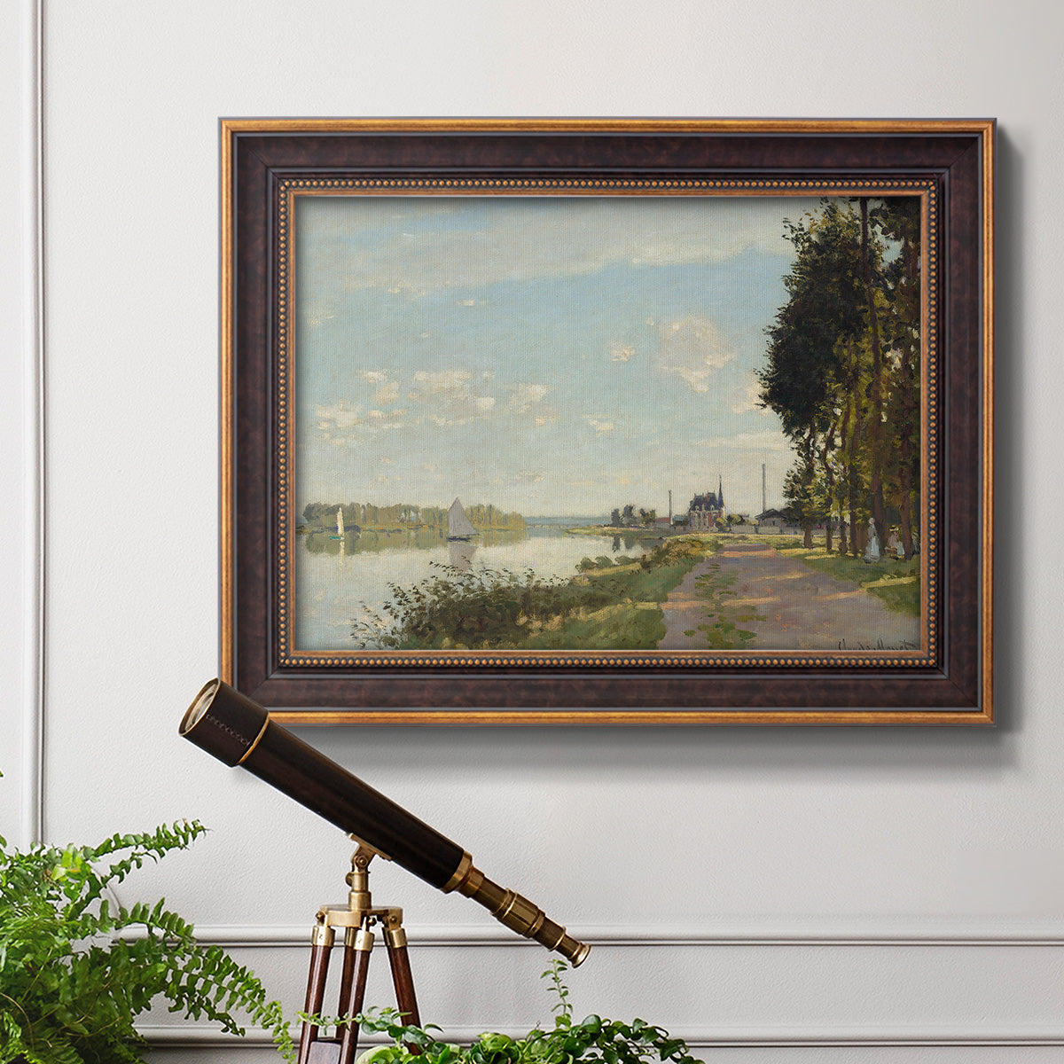 Impressionist river scene with red boats by Claude Monet in an ornate bronzed mahogany wood frame displayed in a light-toned interior setting.