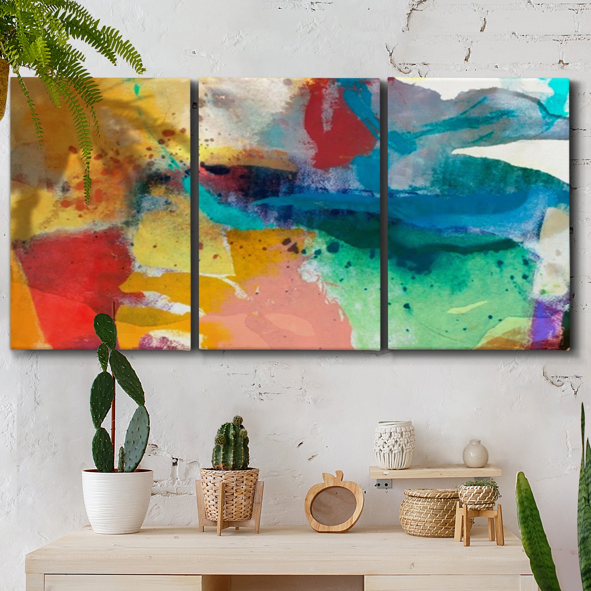 Three-panel canvas wall art featuring layered abstract observational color blocks, displayed in a boho-chic entryway above a console table.
