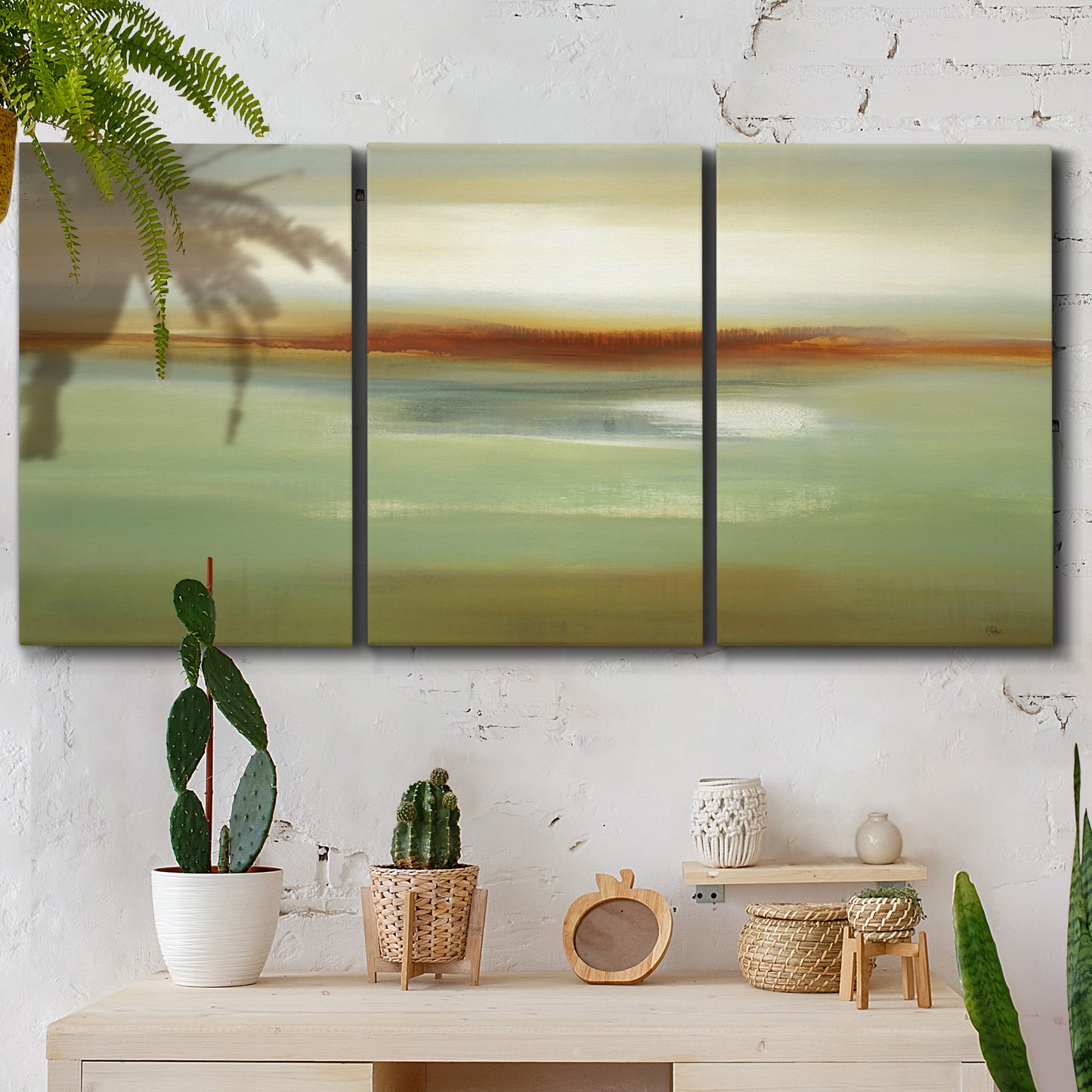 Three-panel canvas wall art featuring green focused abstract color vision, displayed in a boho-chic entryway above a console table.