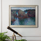 Impressionist rocky seascape by Claude Monet in an ornate champagne frame displayed in a light-toned interior setting.