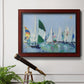 Coastal harbor watercolor painting in an ornate cherry burl wood frame displayed in a light-toned interior setting.