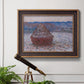 Impressionist single haystack landscape by Claude Monet in an ornate bronzed mahogany wood frame displayed in a light-toned interior setting.