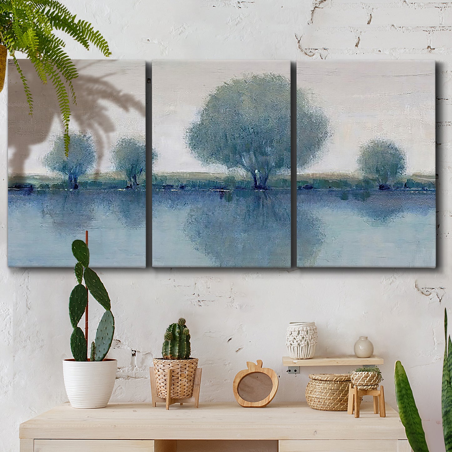 Three-panel canvas wall art featuring calm afternoon river reflection, displayed in a boho-chic entryway above a console table.