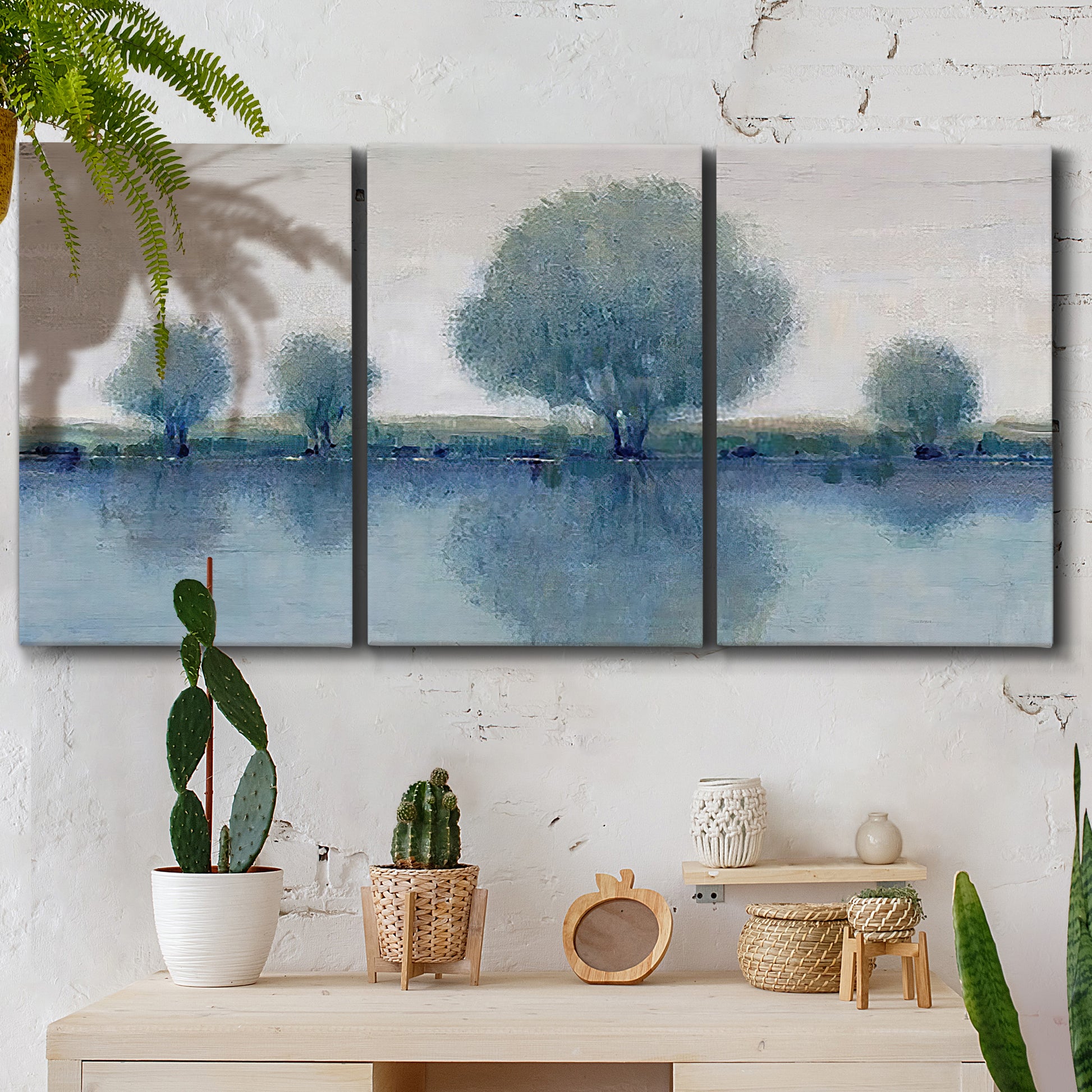 Three-panel canvas wall art featuring calm afternoon river reflection, displayed in a boho-chic entryway above a console table.