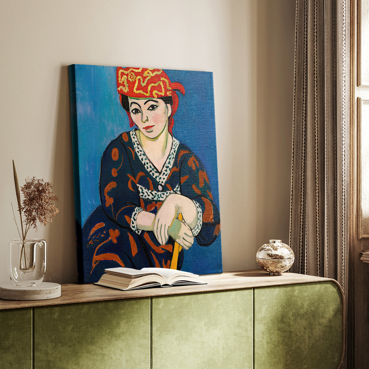 Canvas art print of a stylized face with bold textile pattern and warm tones styled in a home decor setting.