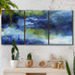 Three-panel canvas wall art featuring flowing blue abstract watercolor, displayed in a boho-chic entryway above a console table.