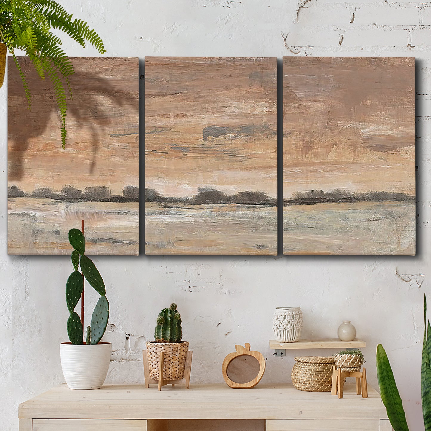 Three-panel canvas wall art featuring soft early evening landscape light, displayed in a boho-chic entryway above a console table.
