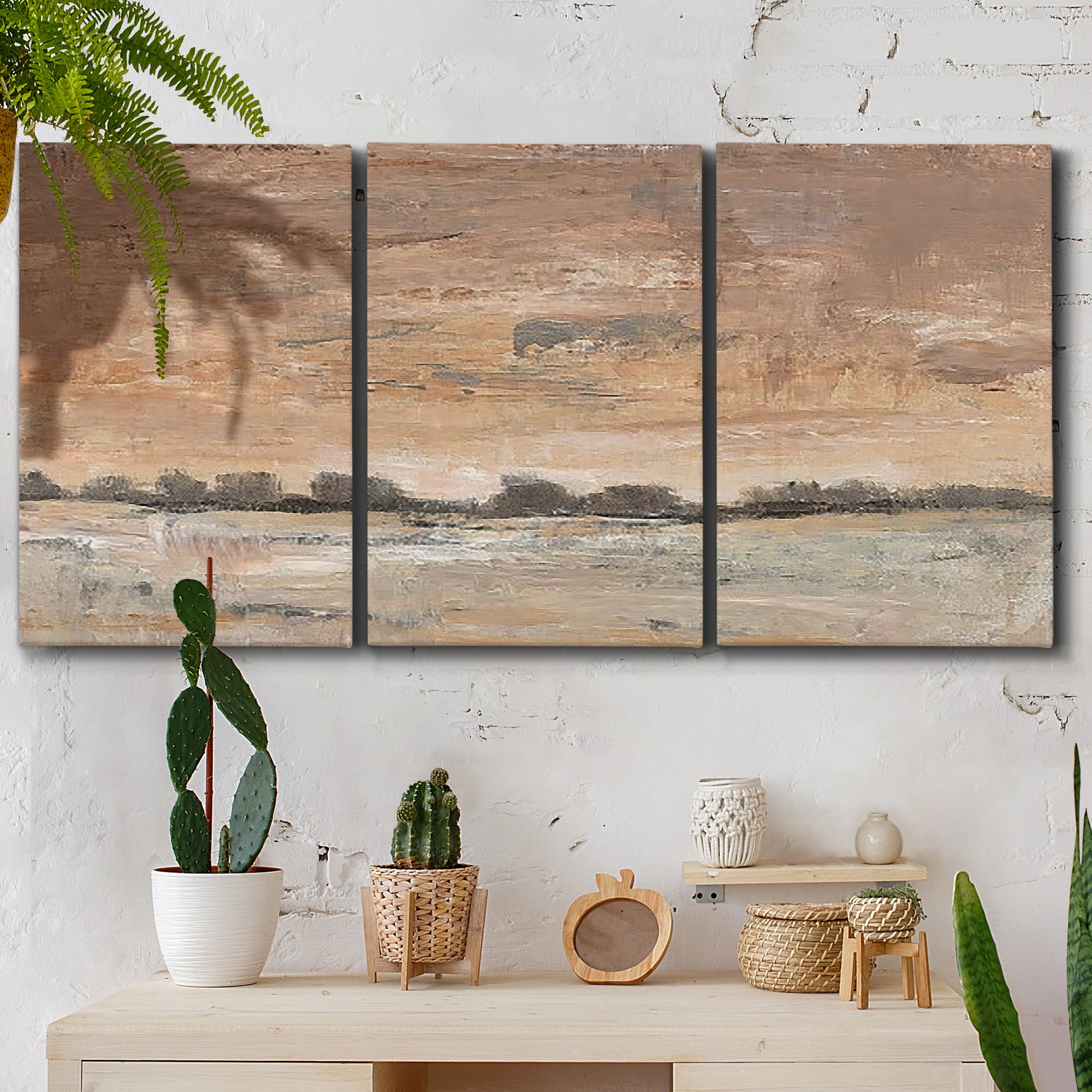 Three-panel canvas wall art featuring soft early evening landscape light, displayed in a boho-chic entryway above a console table.