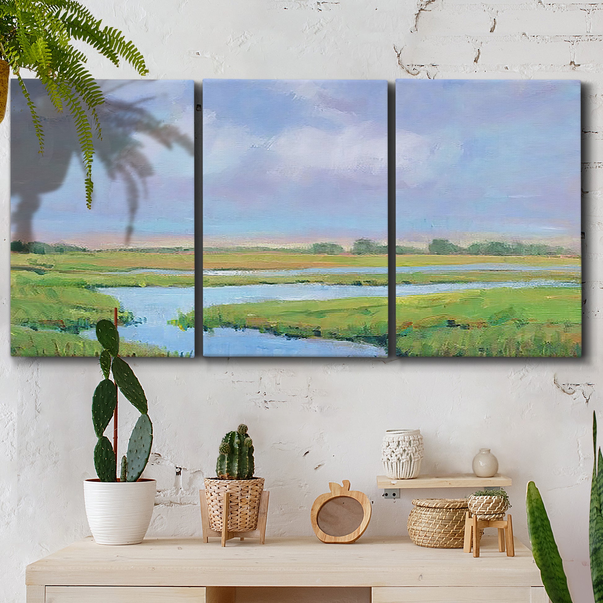Three-panel canvas wall art featuring summer marshland with tall grasses, displayed in a boho-chic entryway above a console table.