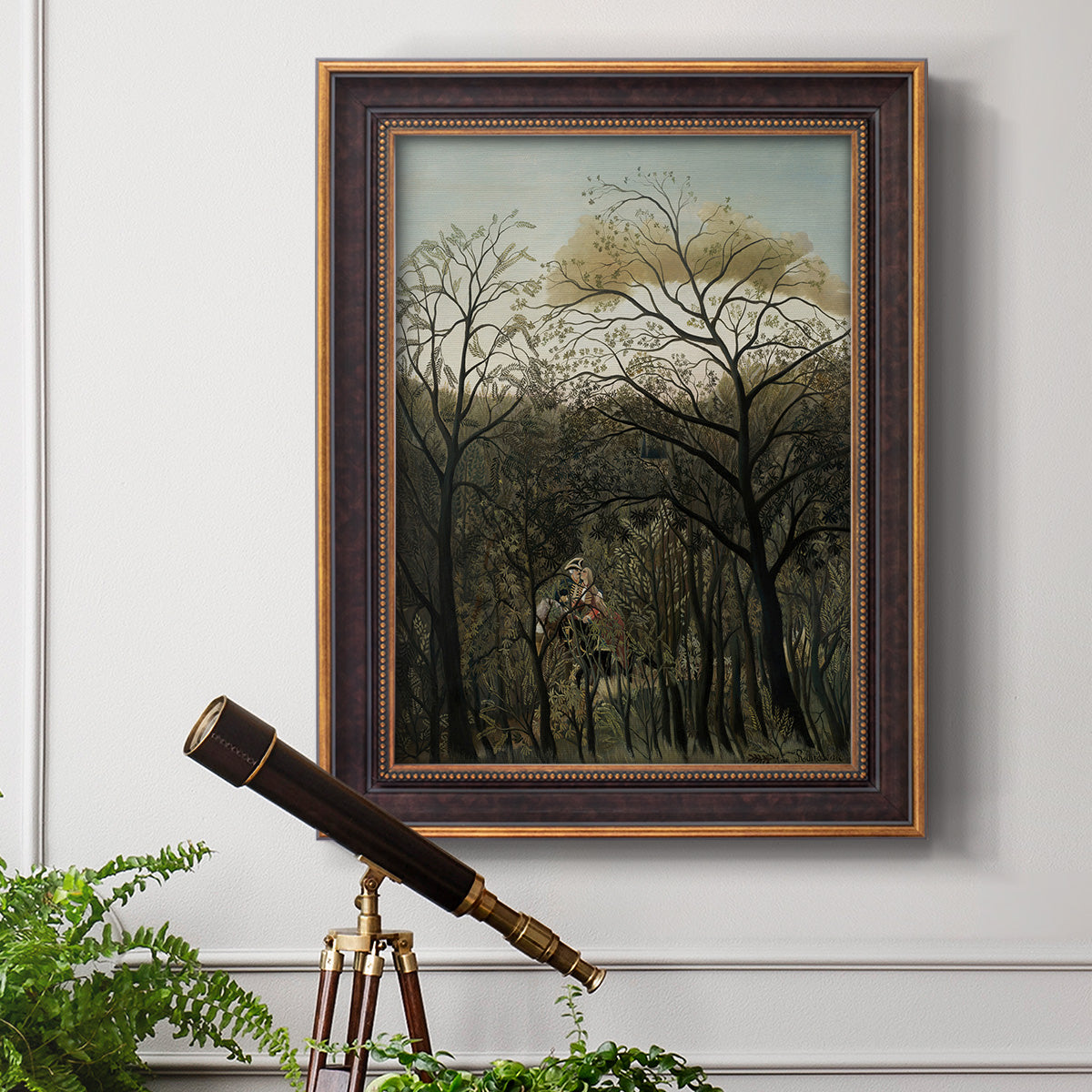 Dreamlike forest landscape scene by Henri Rousseau in an ornate bronzed mahogany wood frame displayed in a light-toned interior setting.