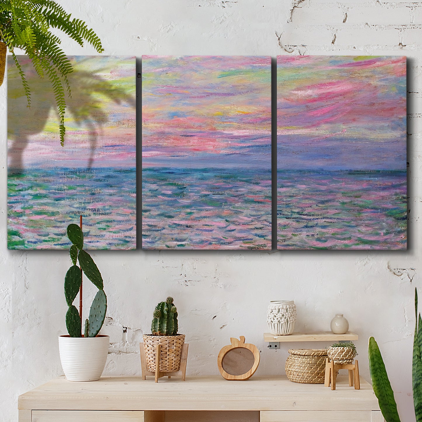 Three-panel canvas wall art featuring sunset reflections across calm sea, displayed in a boho-chic entryway above a console table.