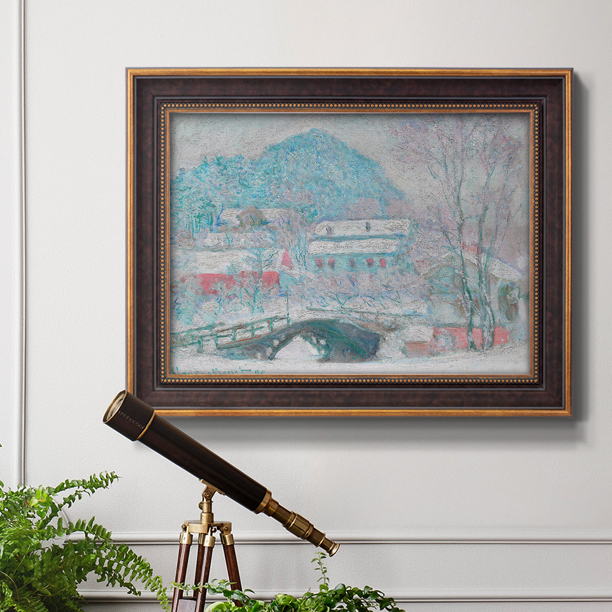 Impressionist coastal village landscape in Norway by Claude Monet in an ornate bronzed mahogany wood frame displayed in a light-toned interior setting.
