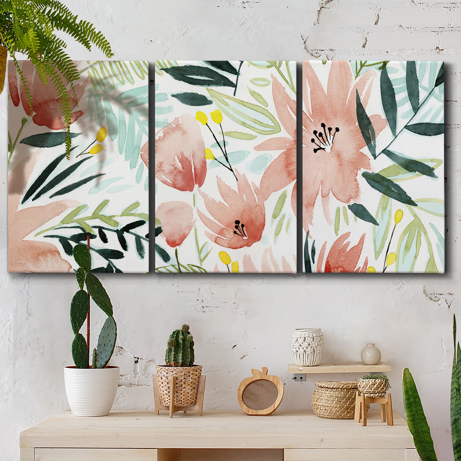 Three-panel canvas wall art featuring layered tropical plant collage, displayed in a boho-chic entryway above a console table.