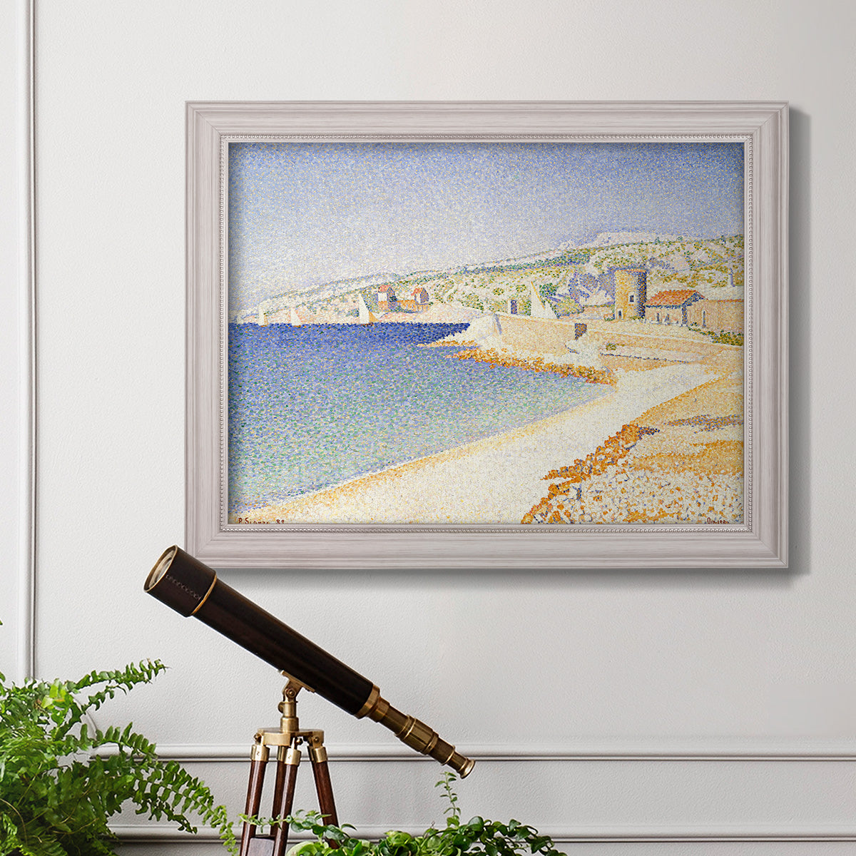 Impressionist Mediterranean jetty seascape by Paul Signac in an ornate weathered white frame displayed in a light-toned interior setting.