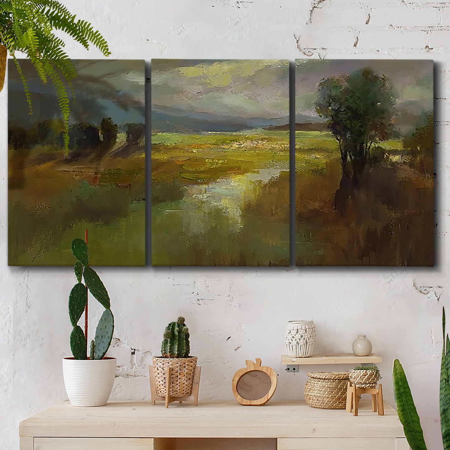 Three-panel canvas wall art featuring winding rural road through countryside, displayed in a boho-chic entryway above a console table.