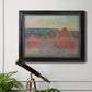 Impressionist haystack series landscape by Claude Monet in an ornate black frame with gilded inner detail displayed in a light-toned interior setting.