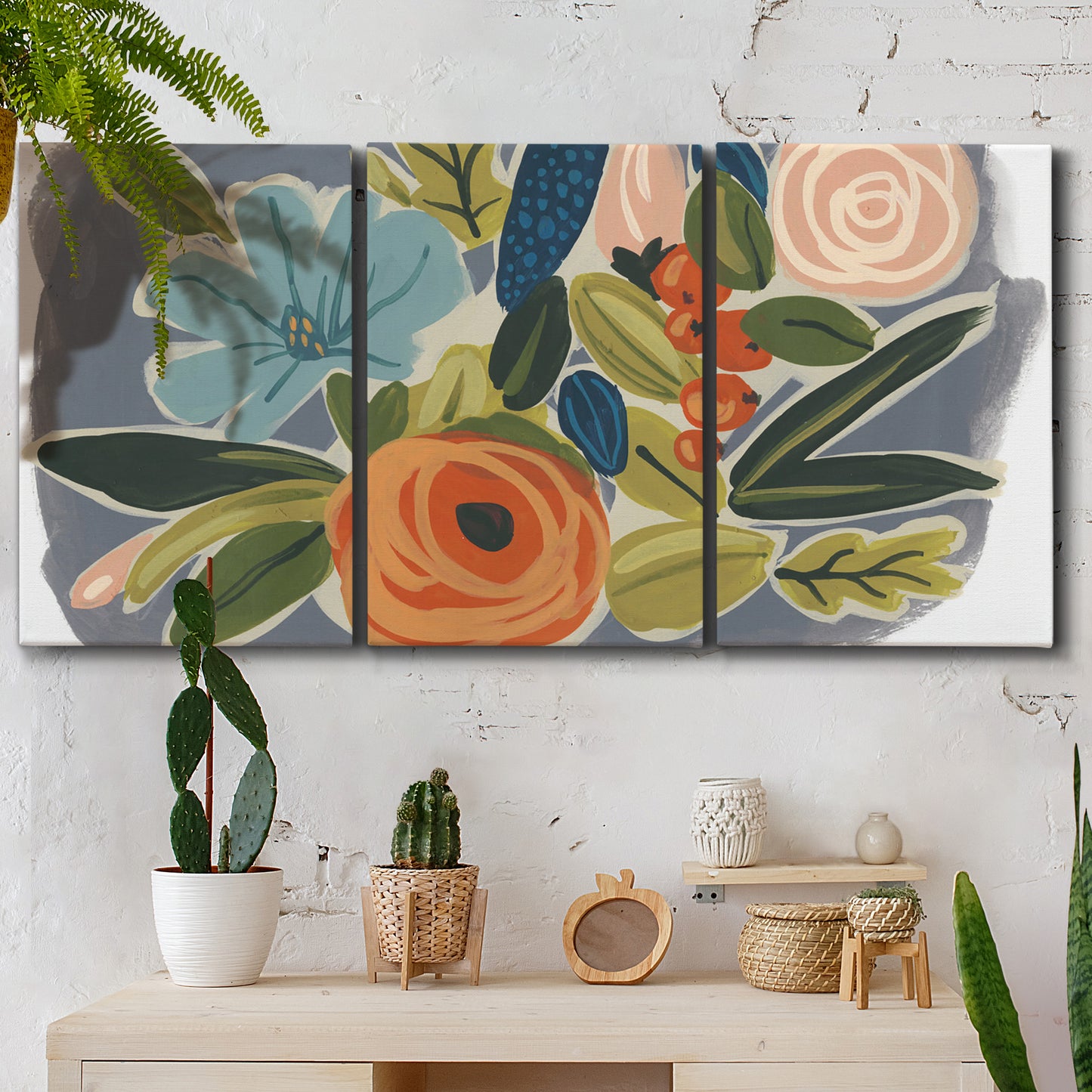 Three-panel canvas wall art featuring colorful botanical illustration, displayed in a boho-chic entryway above a console table.