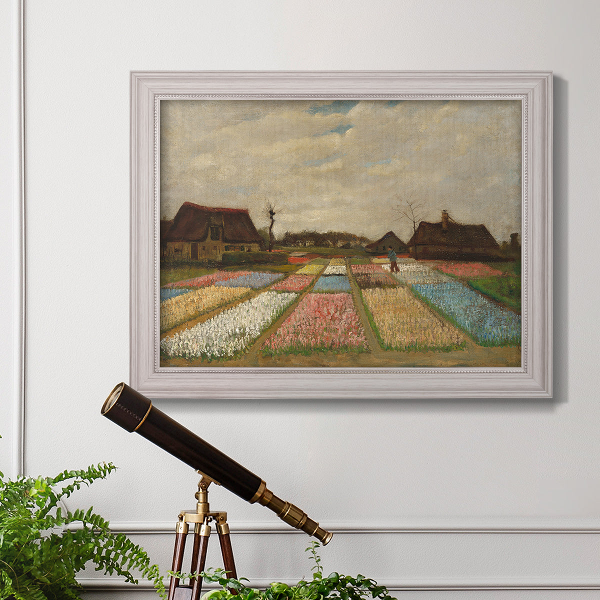 Impressionist Dutch bulb field landscape by Vincent van Gogh in an ornate weathered white frame displayed in a light-toned interior setting.