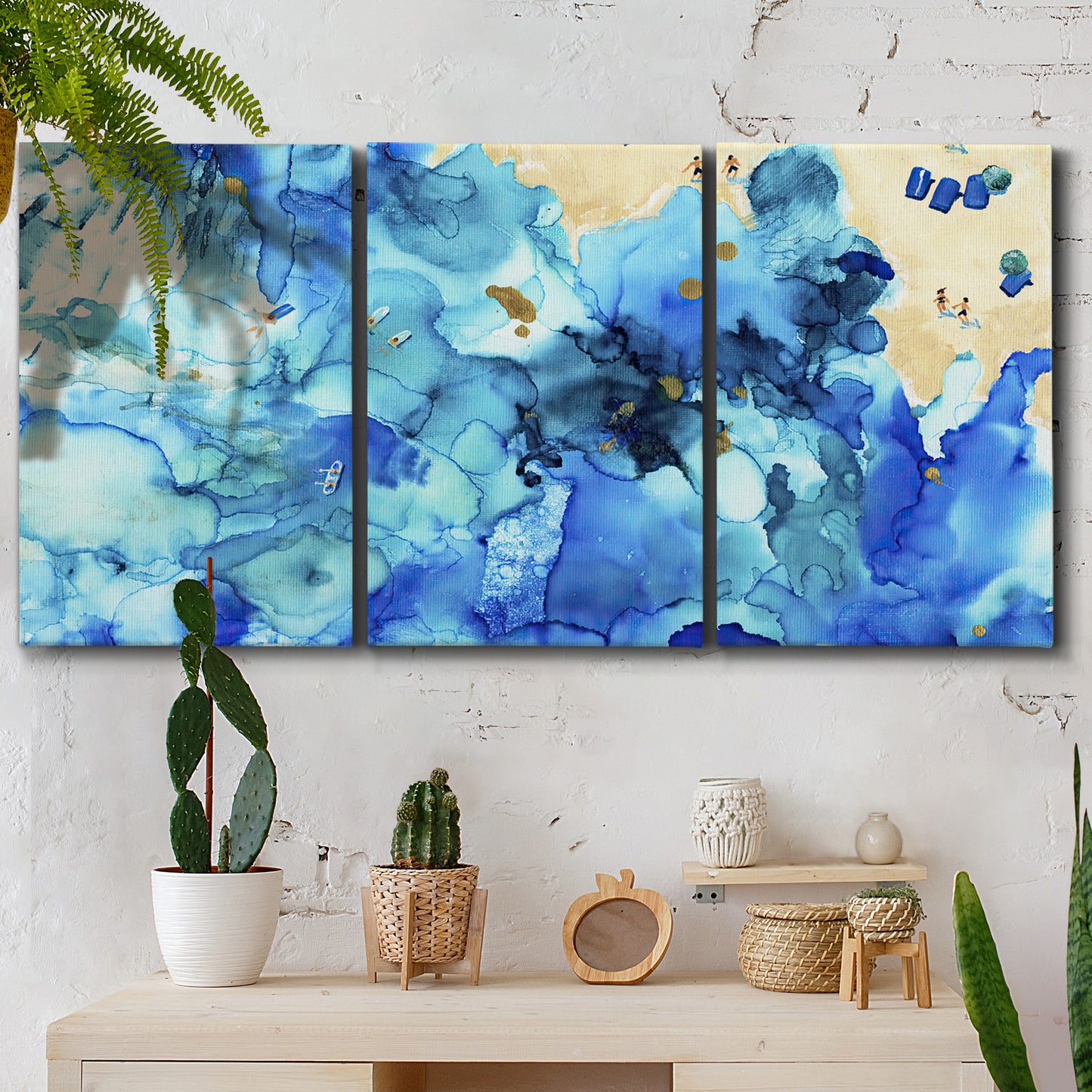 Three-panel canvas wall art featuring abstract coastal beach color fields, displayed in a boho-chic entryway above a console table.