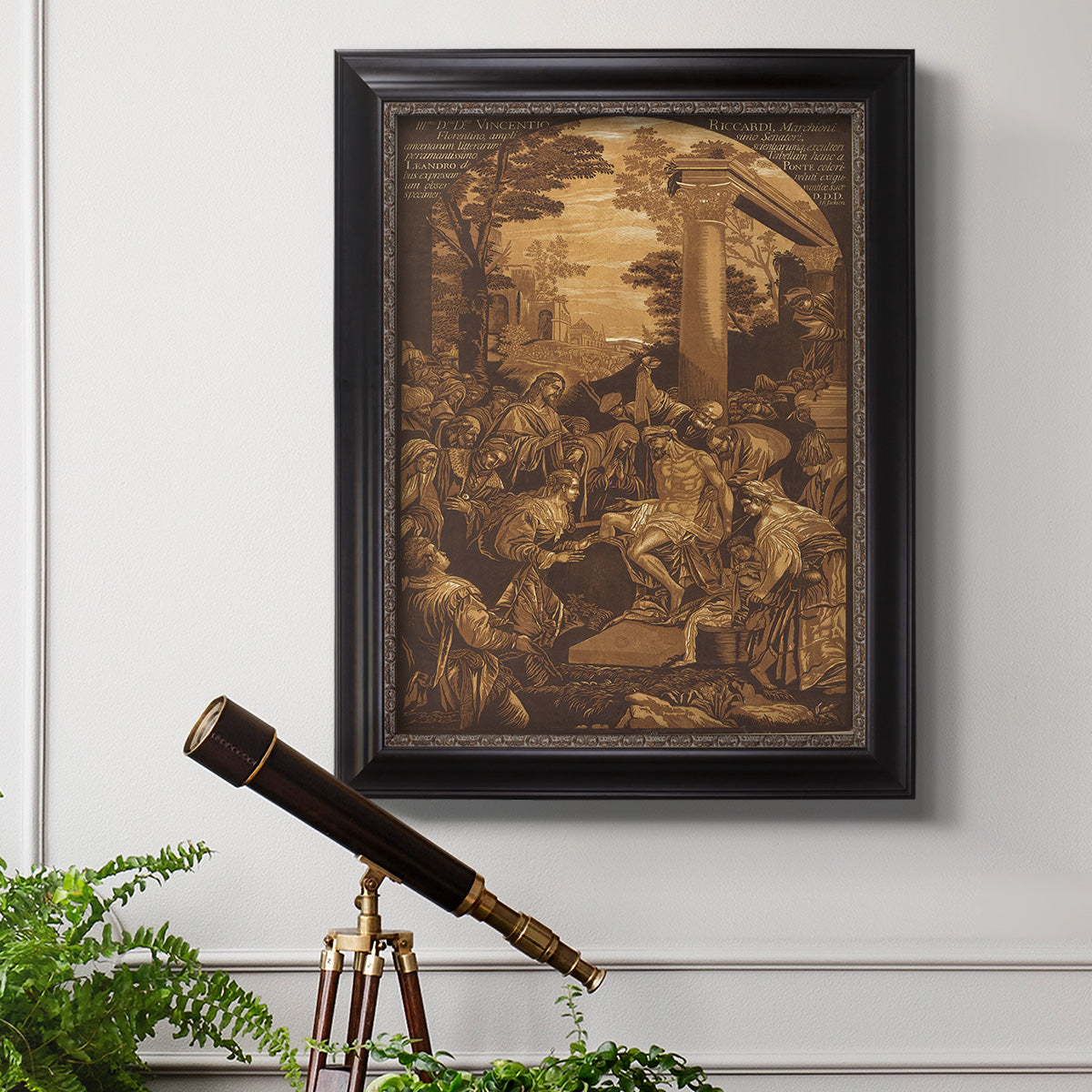 Monochrome religious painting of the raising of Lazarus by Leandro Bassano in an ornate black frame with gilded inner detail displayed in a light-toned interior setting.