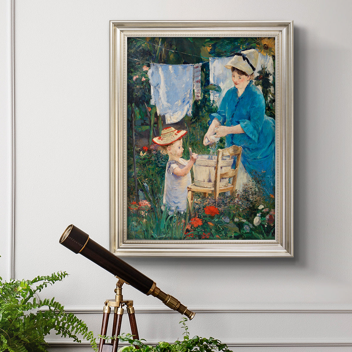 Intimate domestic genre scene by Édouard Manet in an ornate champagne frame displayed in a light-toned interior setting.