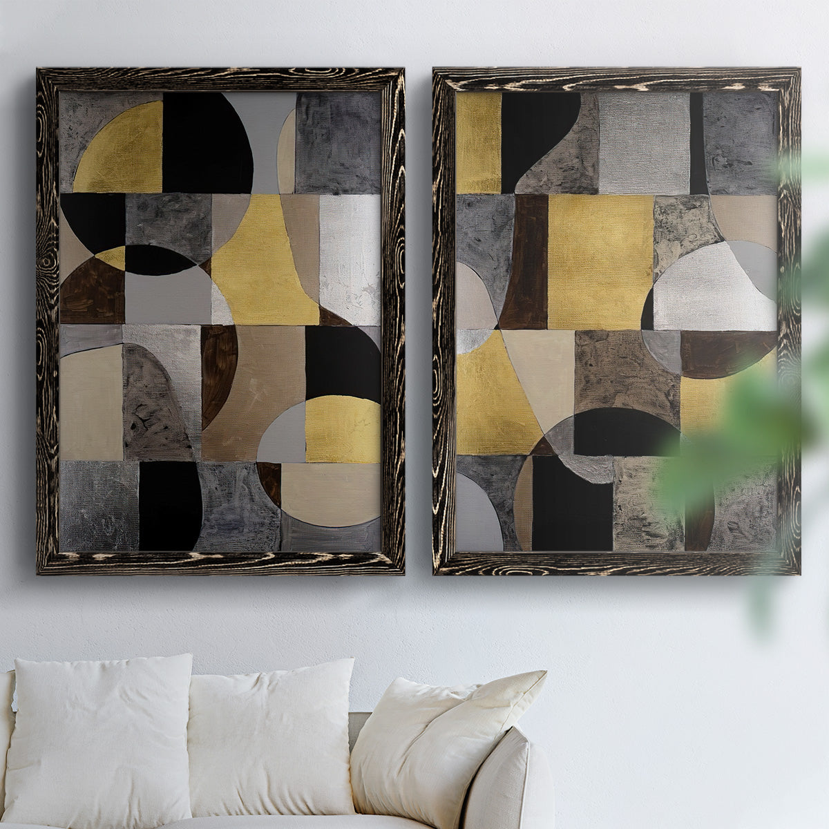 Set of two black barnwood framed canvas prints depicting semicircles, rectangles, textured panels, and metallic-looking accents arranged across two complementary compositions above a sofa in a bright living space.