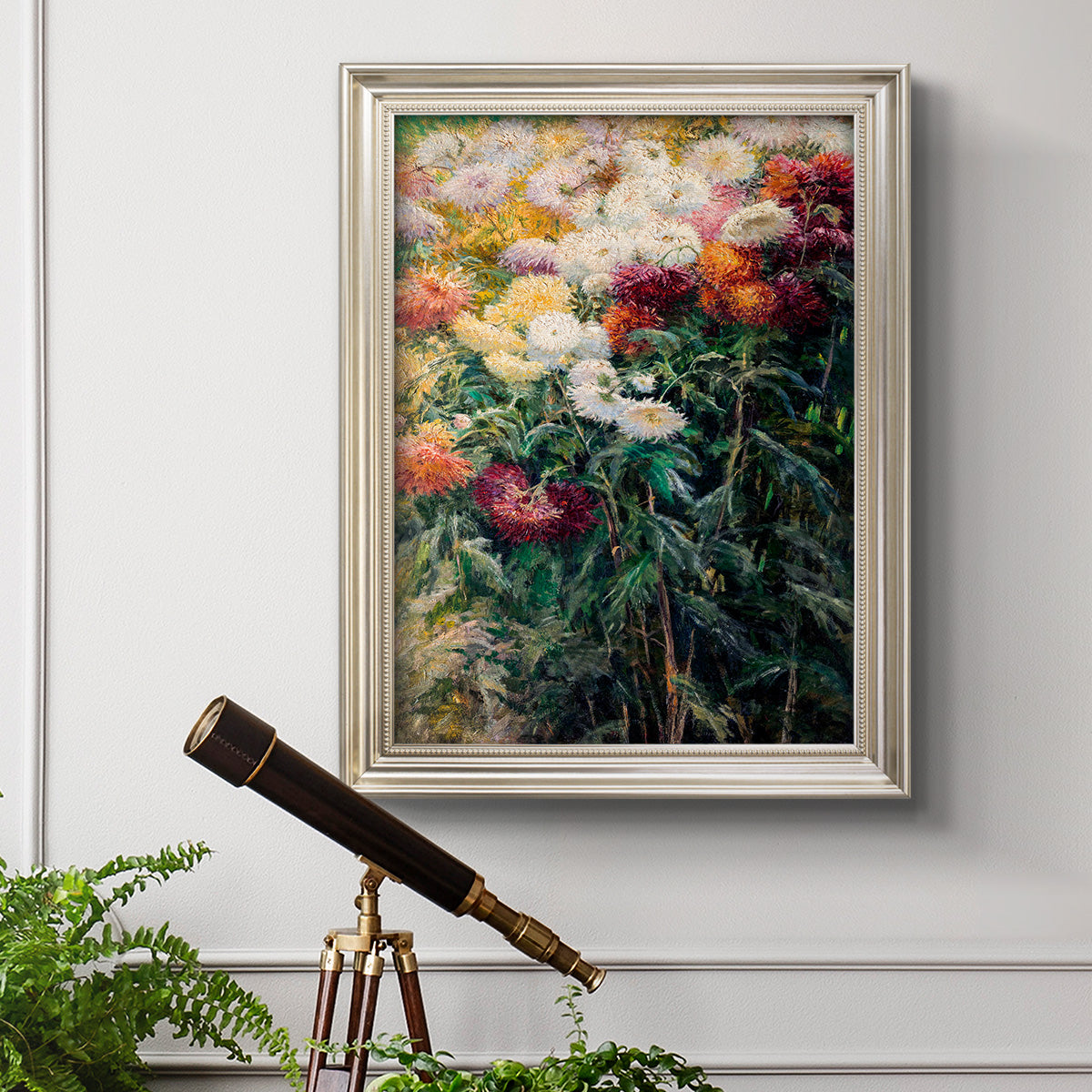 Impressionist garden floral painting by Gustave Caillebotte in an ornate champagne frame displayed in a light-toned interior setting.