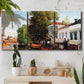 Three-panel canvas wall art featuring riverside houses along canal, displayed in a boho-chic entryway above a console table.