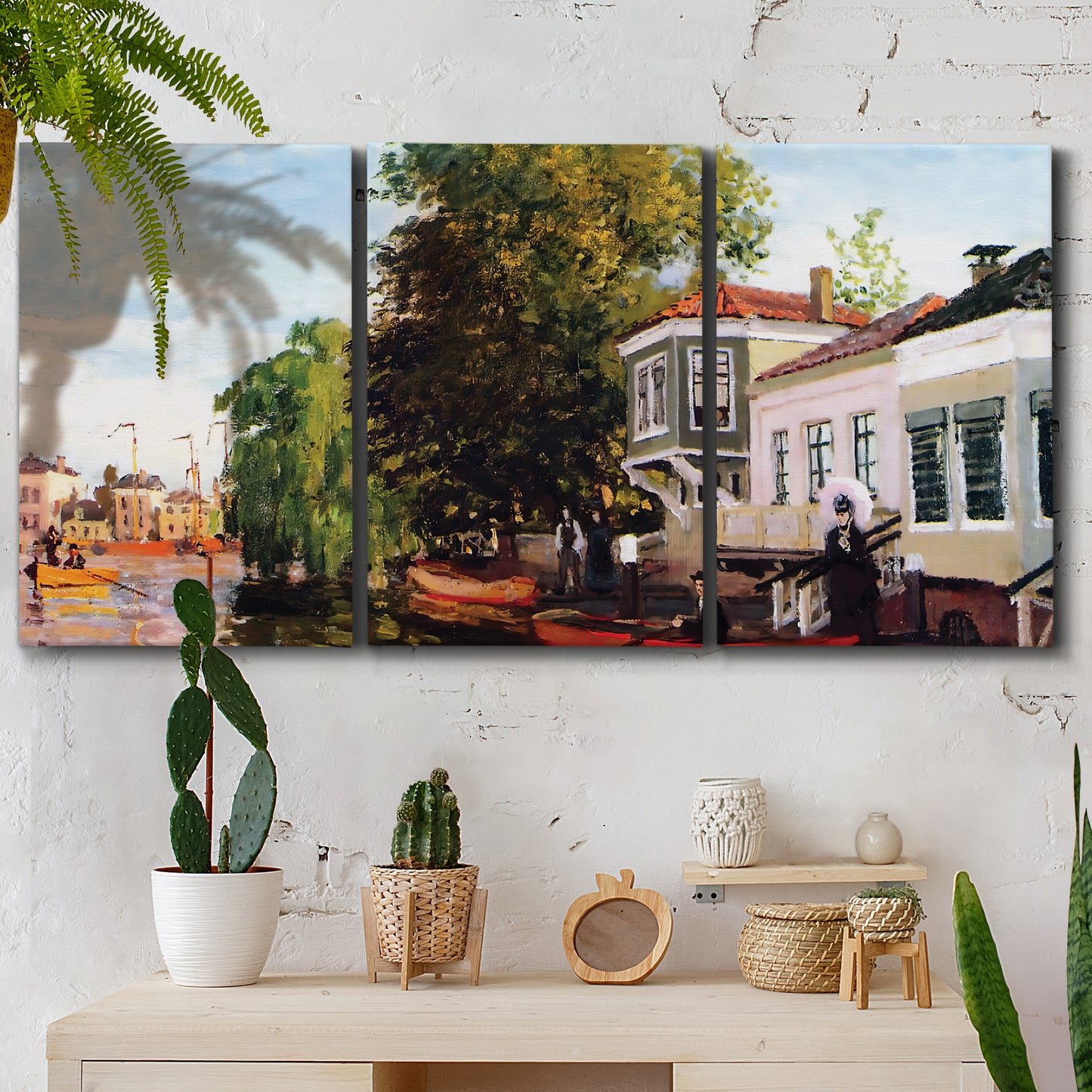 Three-panel canvas wall art featuring riverside houses along canal, displayed in a boho-chic entryway above a console table.