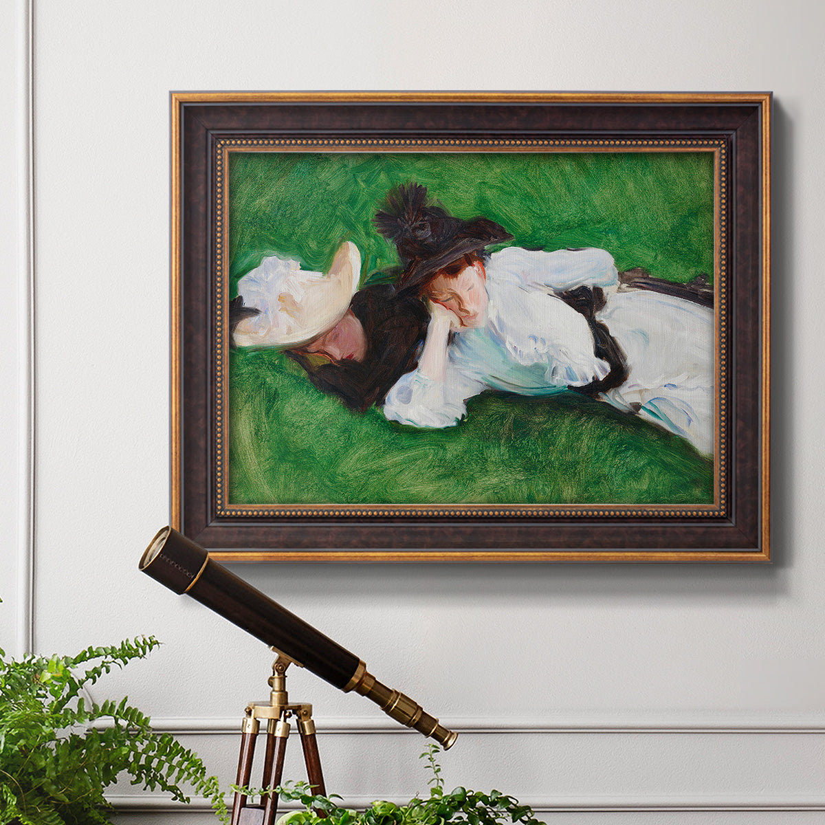 Impressionist outdoor portrait of two girls by John Singer Sargent in an ornate bronzed mahogany wood frame displayed in a light-toned interior setting.