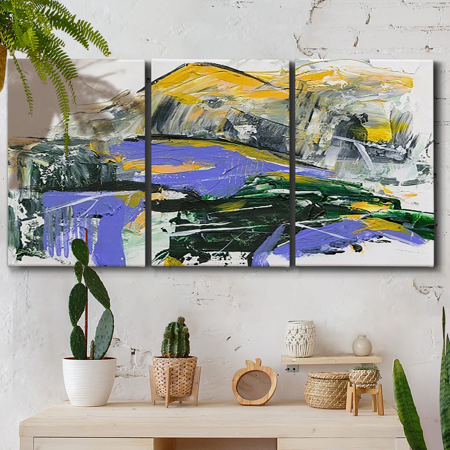 Three-panel canvas wall art featuring quiet abstract mountain silhouette, displayed in a boho-chic entryway above a console table.