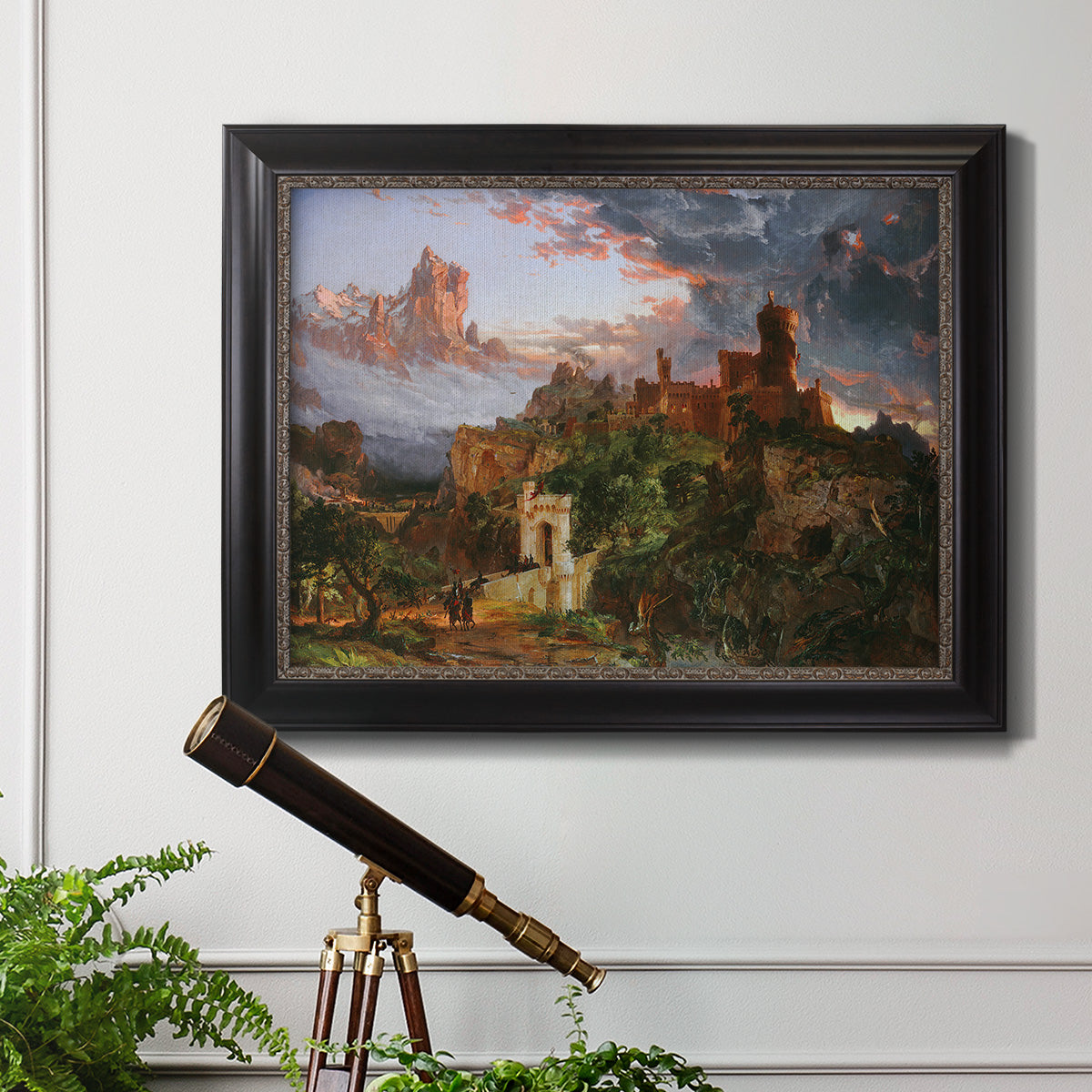 Romantic allegorical landscape painting by Jasper Francis Cropsey in an ornate black frame with gilded inner detail displayed in a light-toned interior setting.