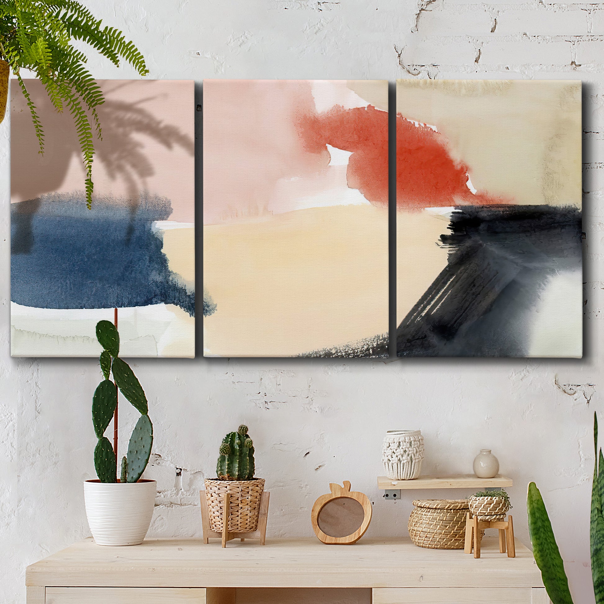Three-panel canvas wall art featuring playful abstract watercolor shapes, displayed in a boho-chic entryway above a console table.