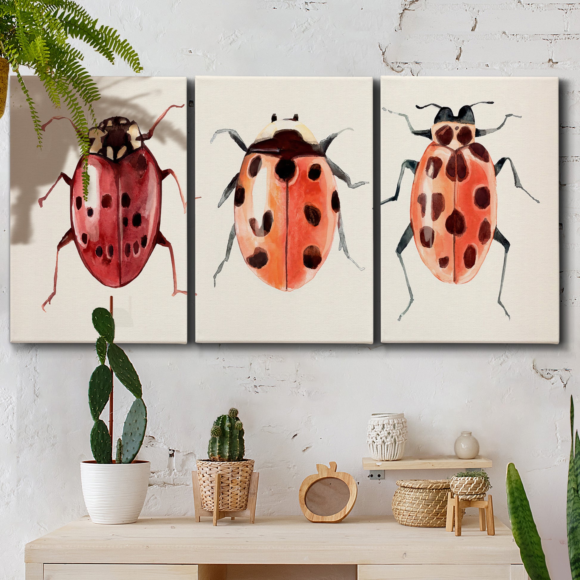Three-panel canvas wall art featuring ladybugs on green foliage, displayed in a boho-chic entryway above a console table.