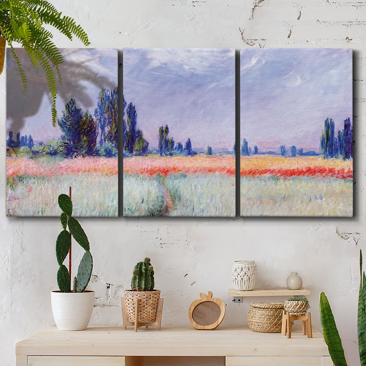 Three-panel canvas wall art featuring flowering field with poppies, displayed in a boho-chic entryway above a console table.
