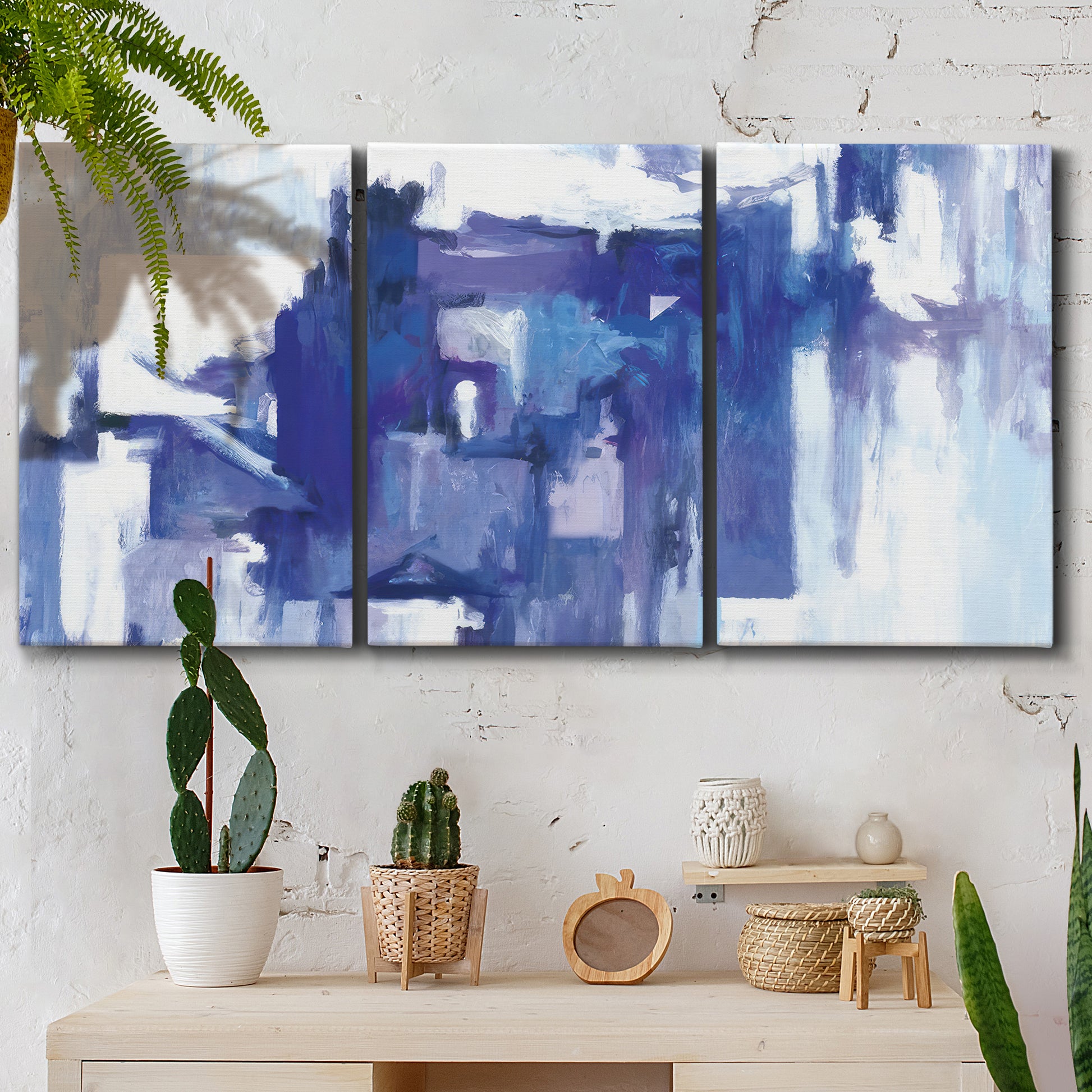Three-panel canvas wall art featuring abstract urban street scene, displayed in a boho-chic entryway above a console table.