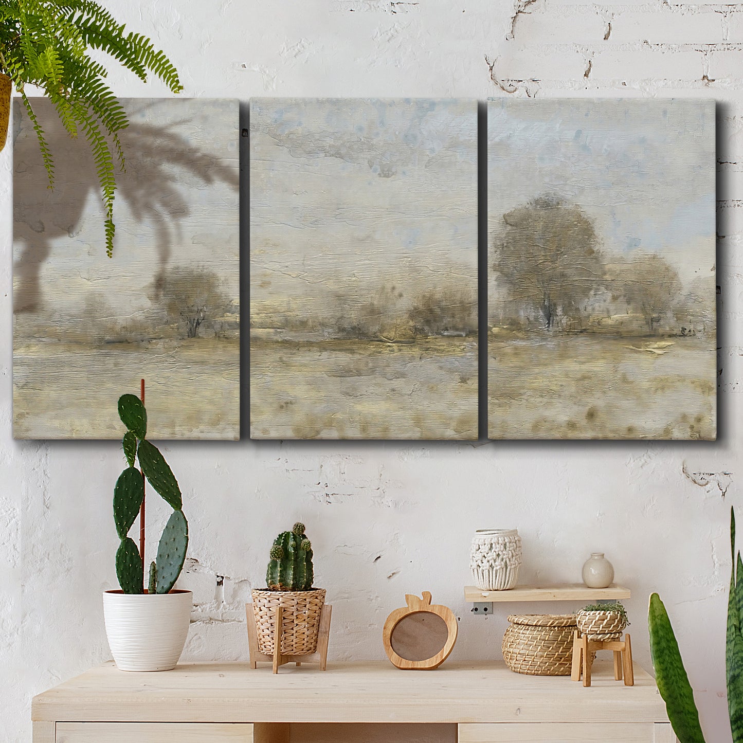 Three-panel canvas wall art featuring late season rural harvest fields, displayed in a boho-chic entryway above a console table.
