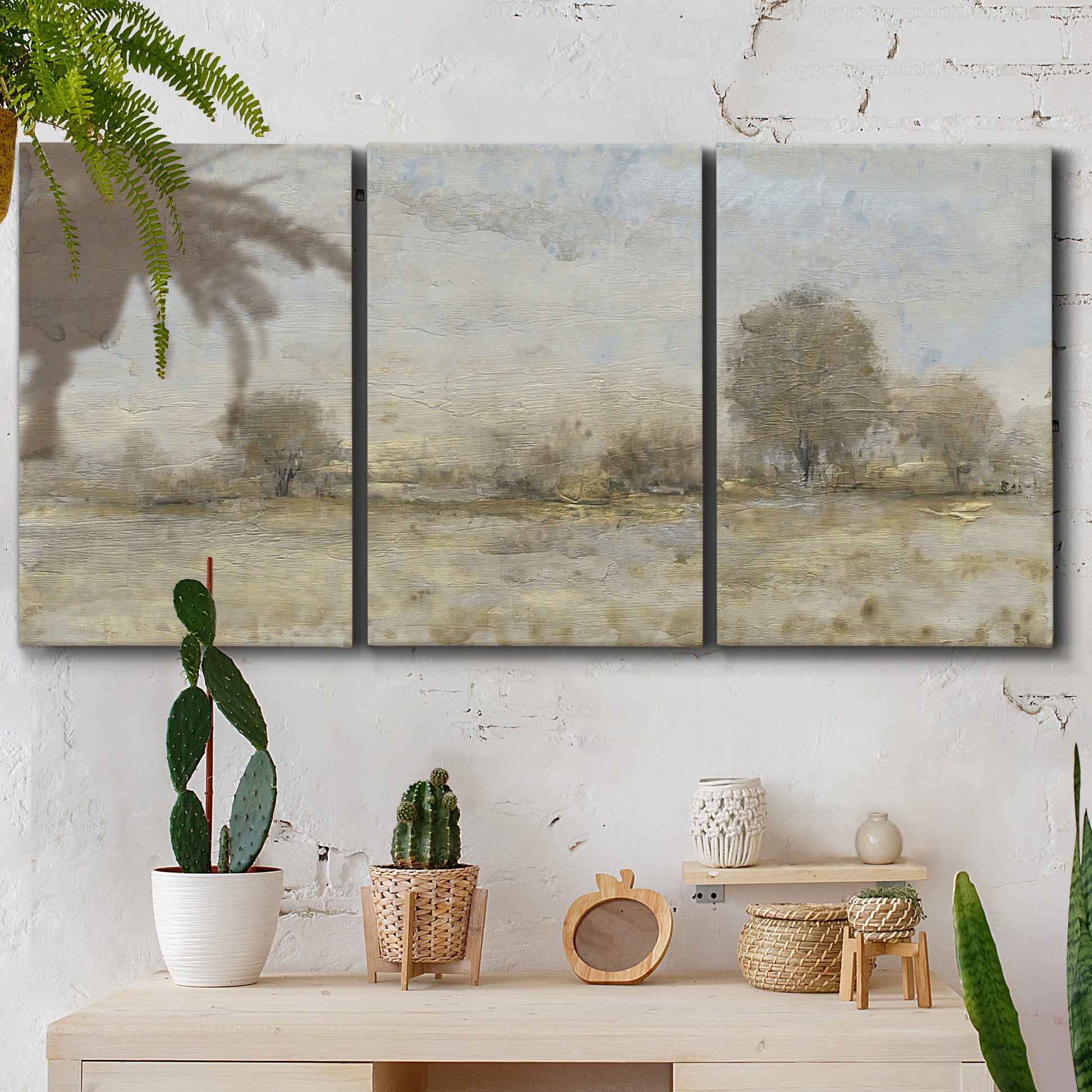 Three-panel canvas wall art featuring late season rural harvest fields, displayed in a boho-chic entryway above a console table.
