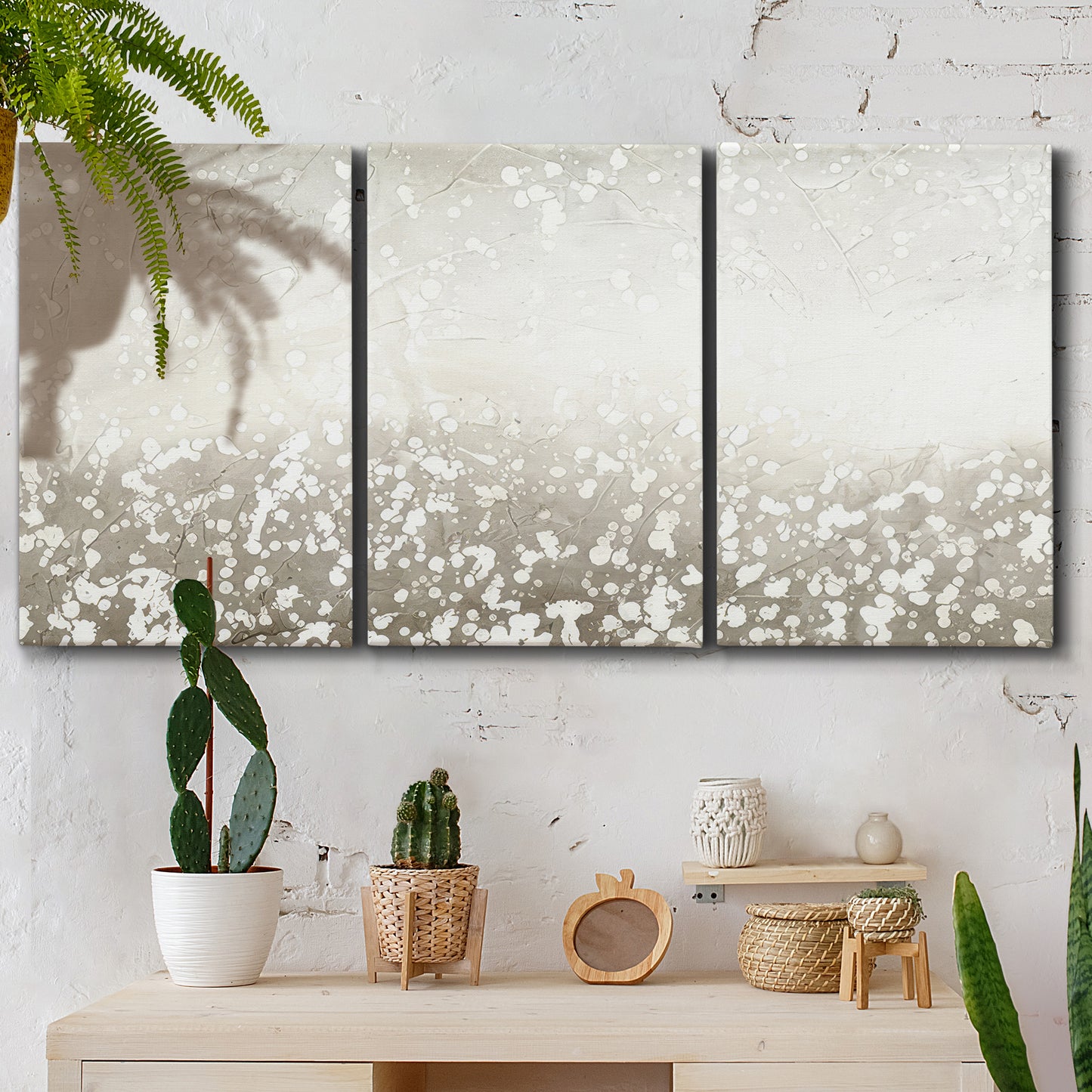 Three-panel canvas wall art featuring dark textured abstract mist, displayed in a boho-chic entryway above a console table.