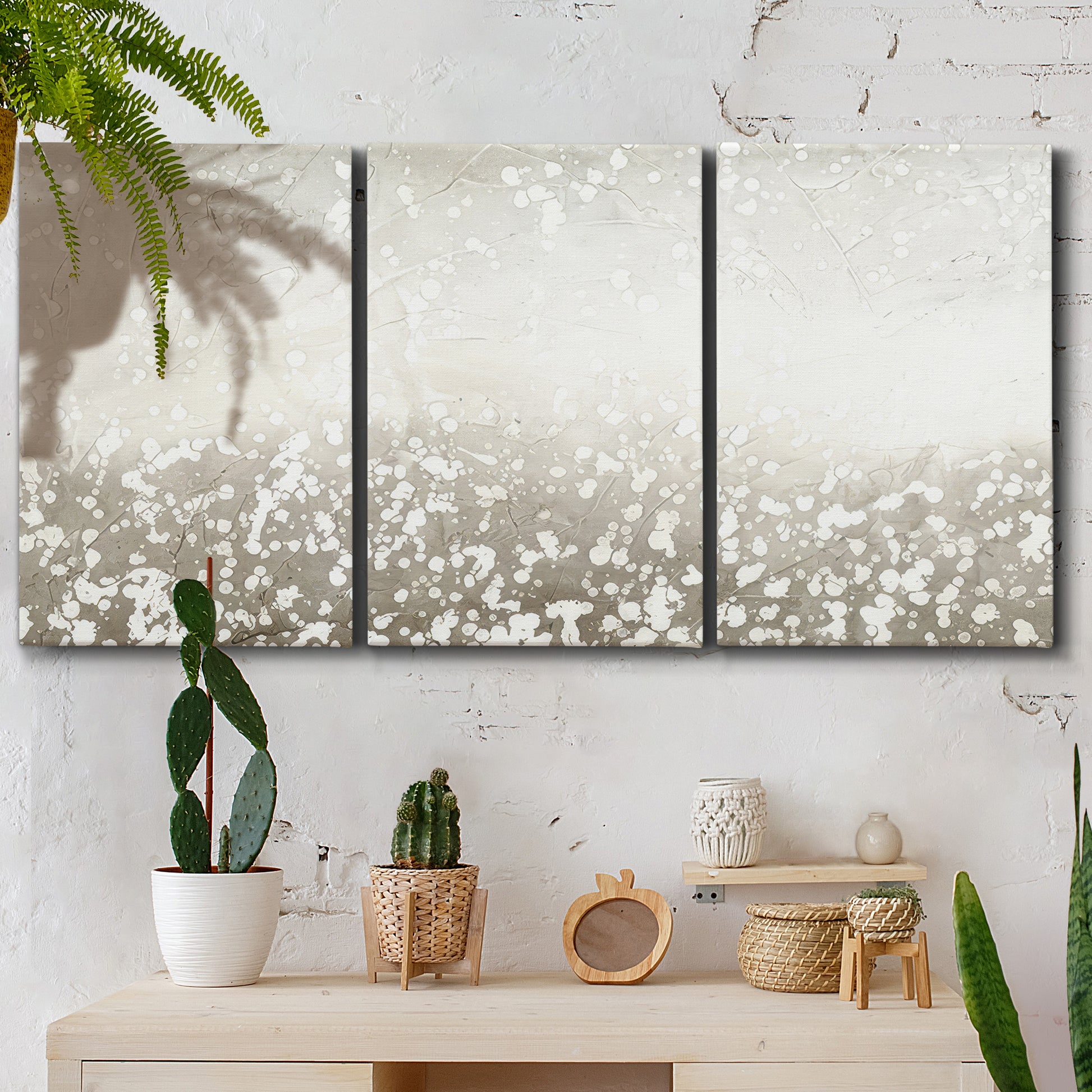 Three-panel canvas wall art featuring dark textured abstract mist, displayed in a boho-chic entryway above a console table.