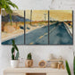 Three-panel canvas wall art featuring empty highway stretching through landscape, displayed in a boho-chic entryway above a console table.