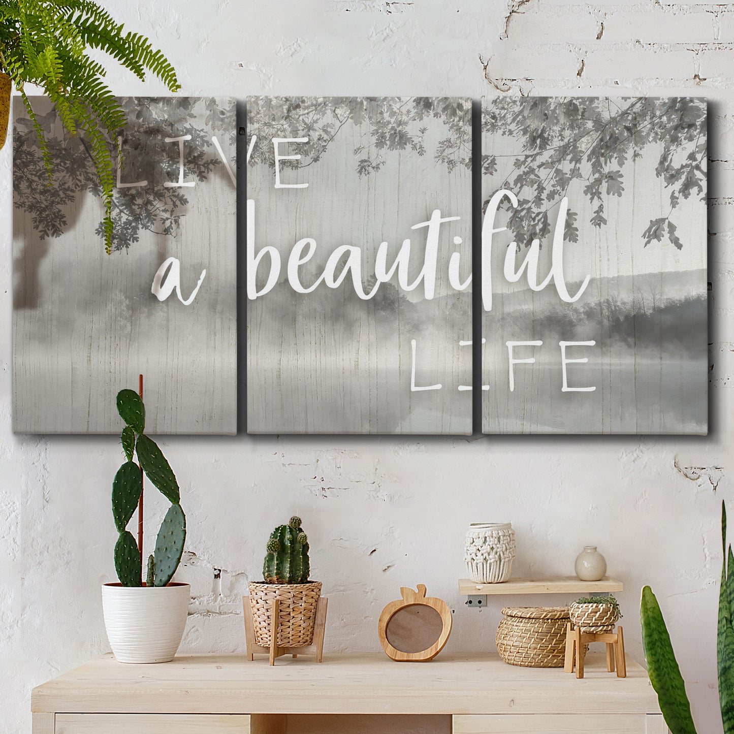 Three-panel canvas wall art featuring uplifting life themed typography, displayed in a boho-chic entryway above a console table.