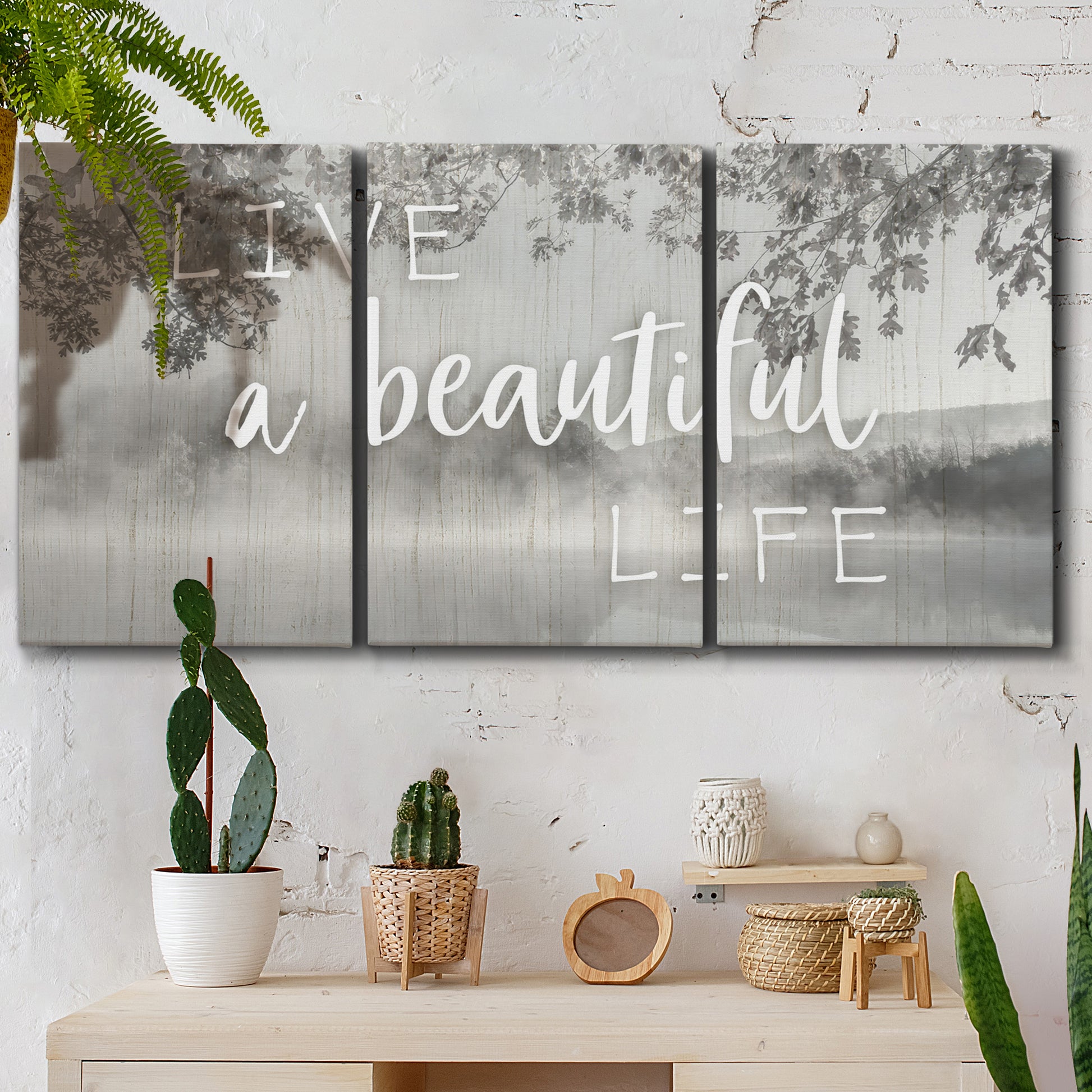 Three-panel canvas wall art featuring uplifting life themed typography, displayed in a boho-chic entryway above a console table.