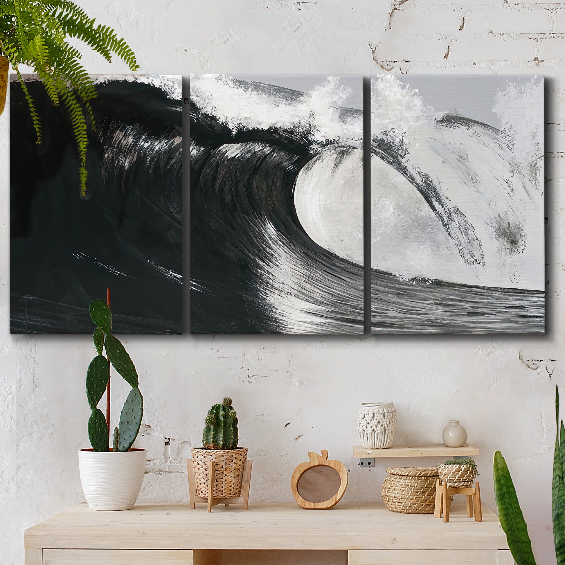 Three-panel canvas wall art featuring black and white crashing ocean waves, displayed in a boho-chic entryway above a console table.